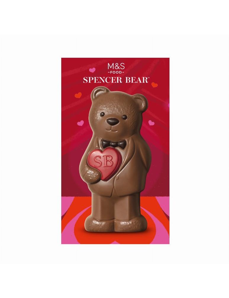 Dutá figurka z mléčné čokolády ozdobená červenými kakaovými cukrovinkami a hořkou čokoládou